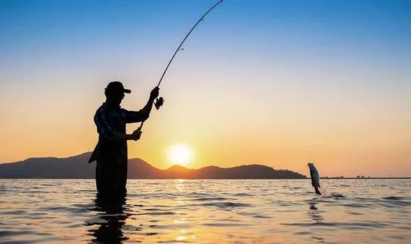 man fishing in lake